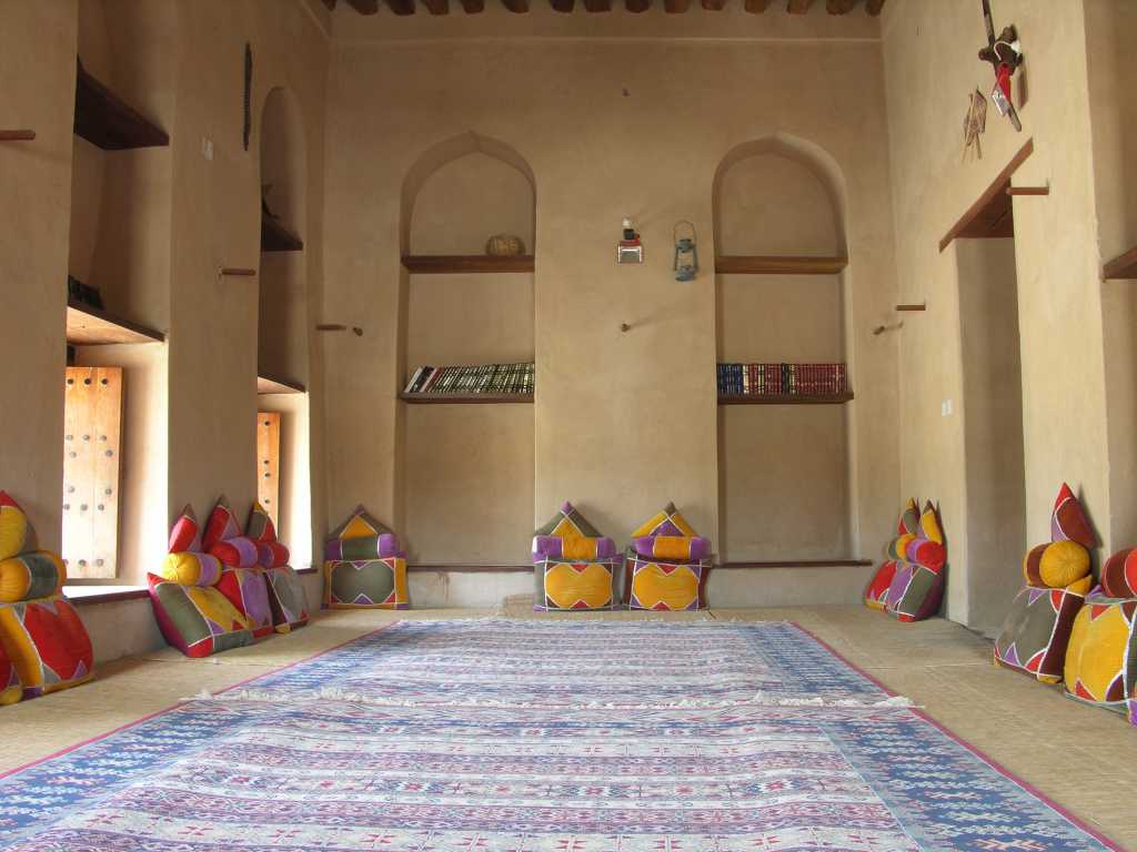 Muscat 06 Nizwa 11 Fort Typical Room With Cushions The Nizwa Fort is huge with a jumble of corridors and staircases. Several of the rooms have been restored, including this one with colourful cushions to sit on the floor.